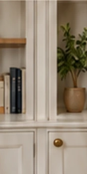 Illustrative cabinet detail with shelves and brass drawer handle